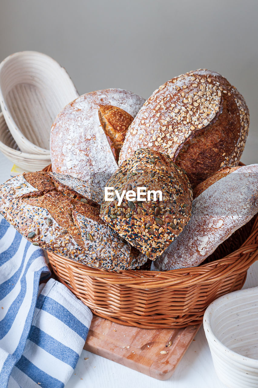 Selection of freshly baked organic sourdough loafs of bread in basket.