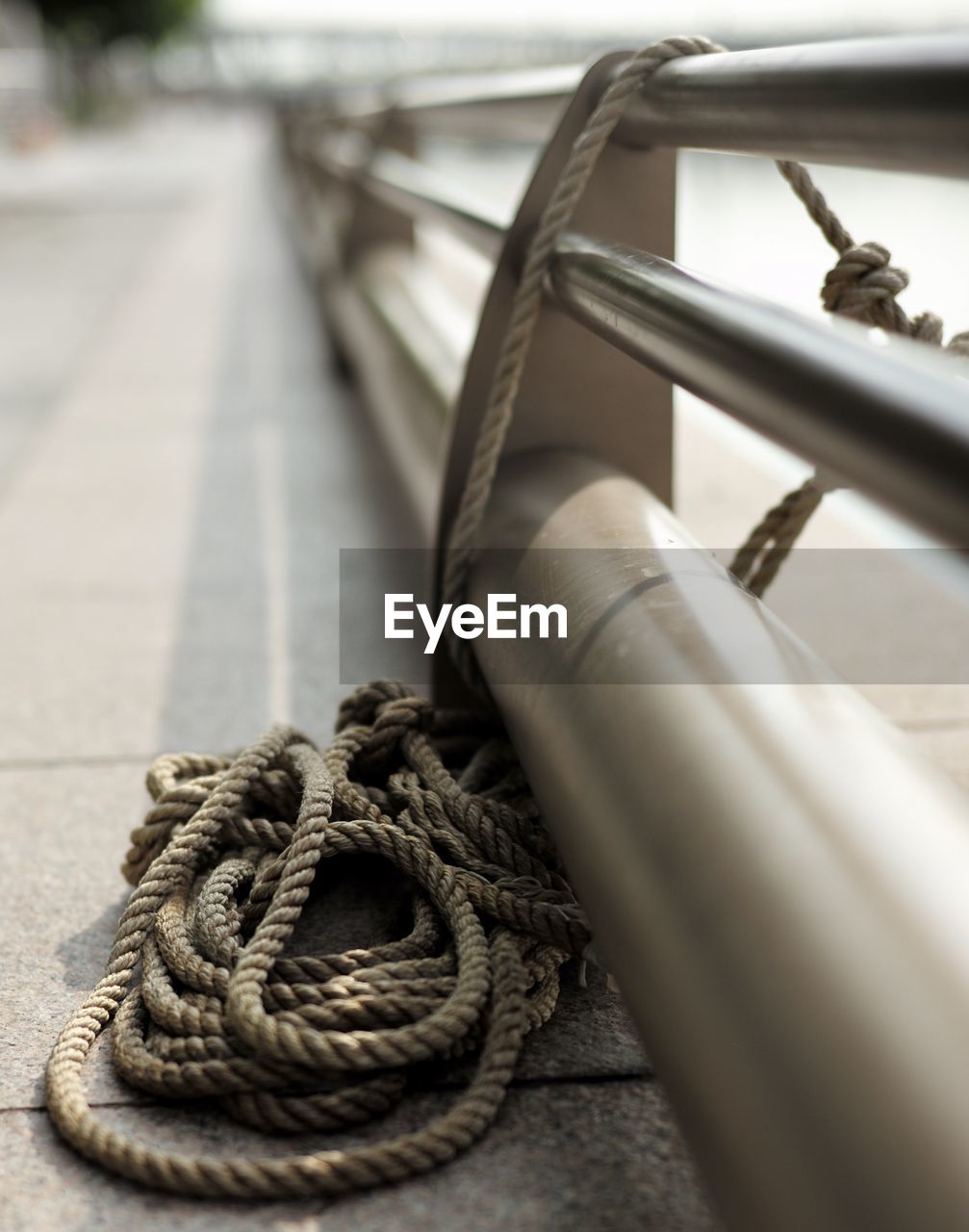Close-up of rope tied on metal railing