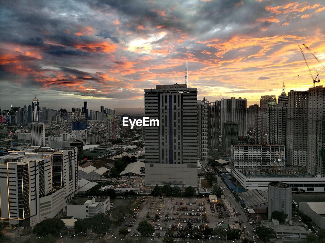 View of cityscape against cloudy sky during sunset