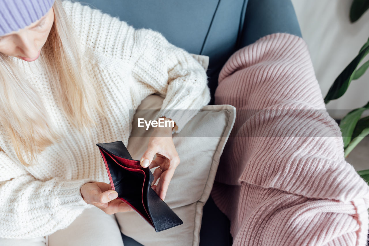 high angle view of woman sitting on sofa at home