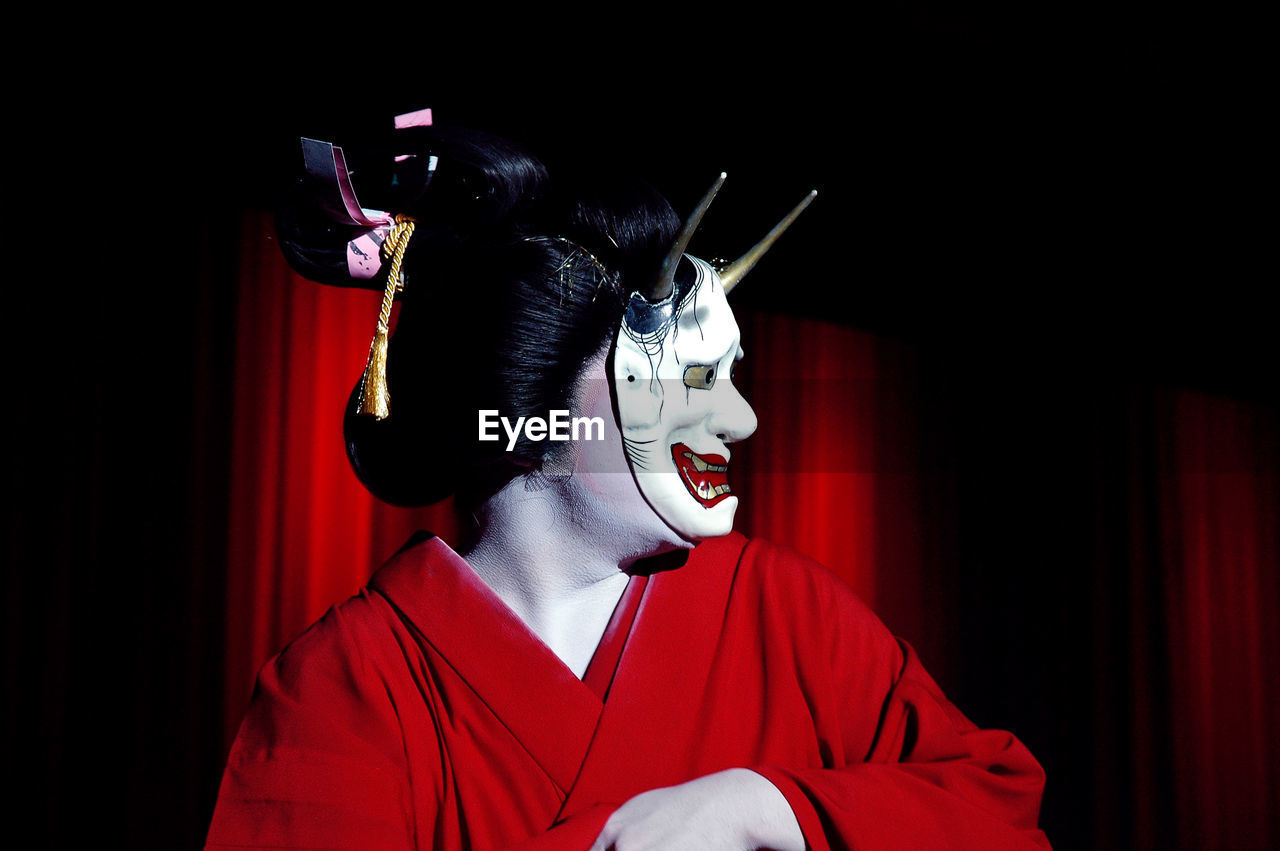Close-up of japanese woman wearing traditional clothing and mask