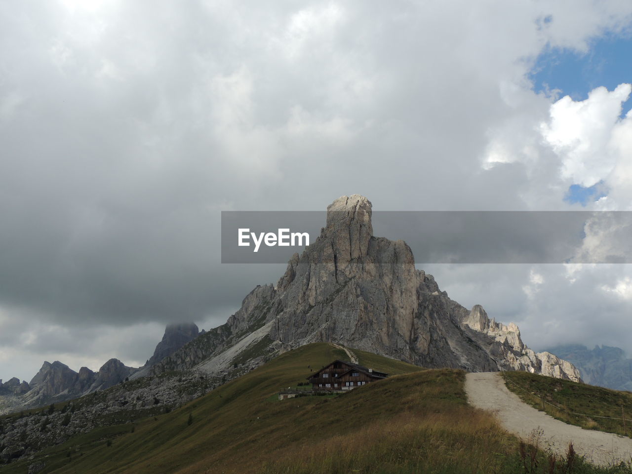 SCENIC VIEW OF MOUNTAINS AGAINST CLOUDY SKY