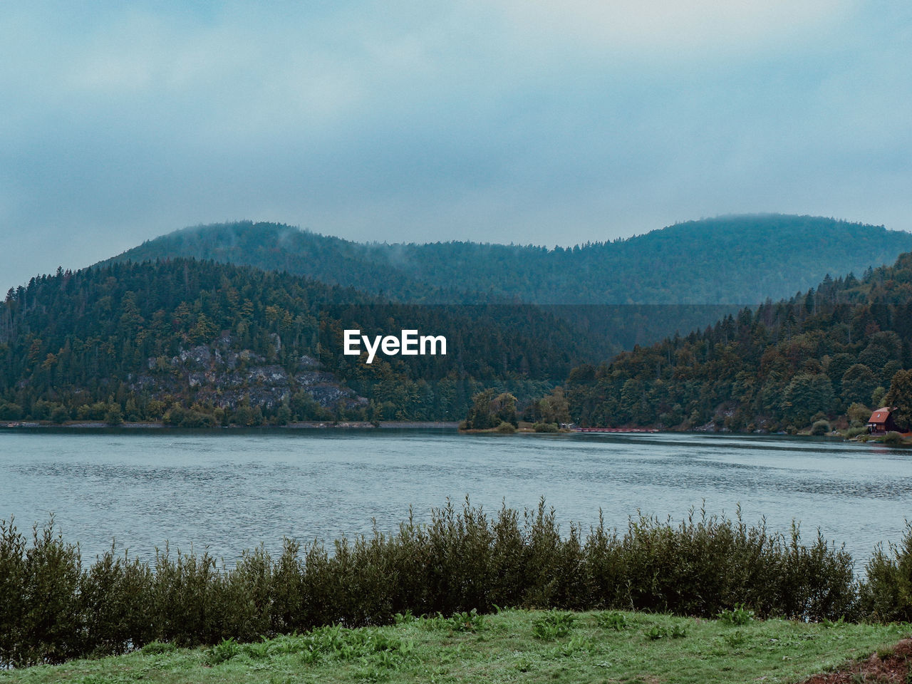 Scenic view of lake and mountains against sky