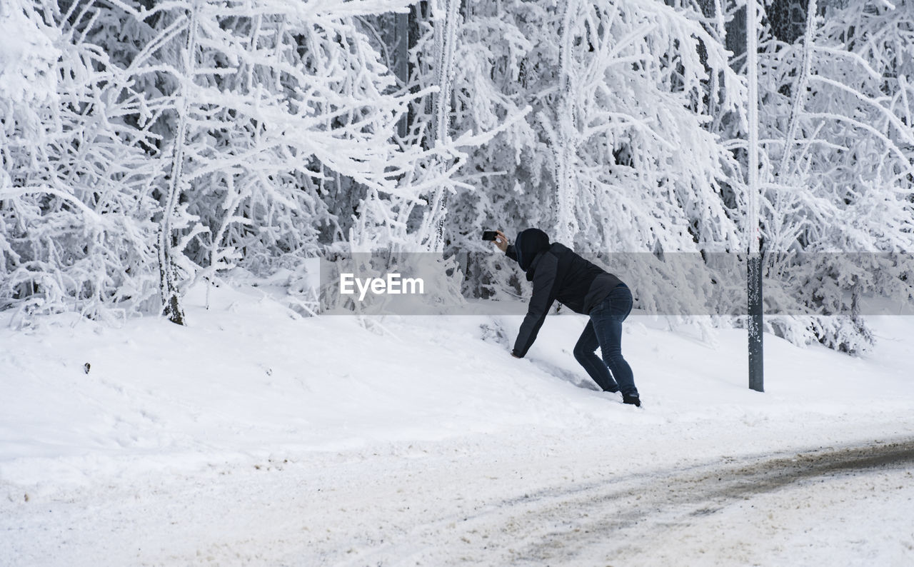 PERSON WALKING ON SNOW COVERED LAND