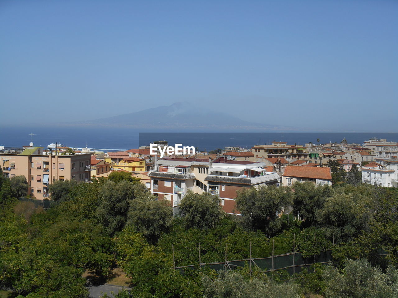 HIGH ANGLE VIEW OF BUILDINGS AGAINST CLEAR SKY