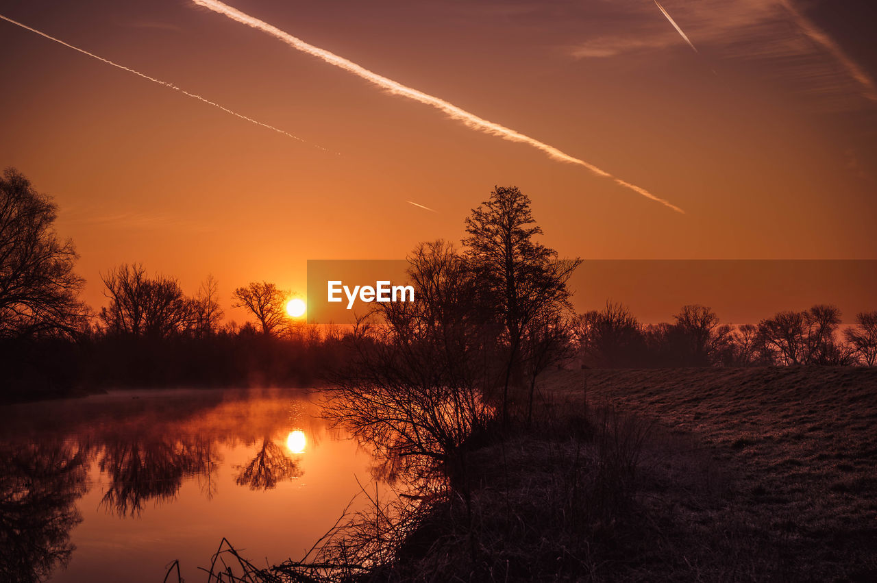 SCENIC VIEW OF LAKE AGAINST ROMANTIC SKY DURING SUNSET