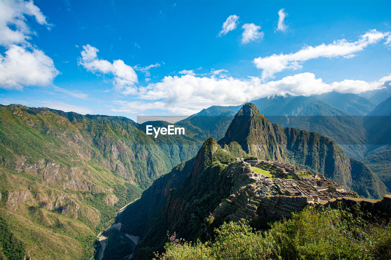 PANORAMIC VIEW OF MOUNTAIN RANGE AGAINST SKY