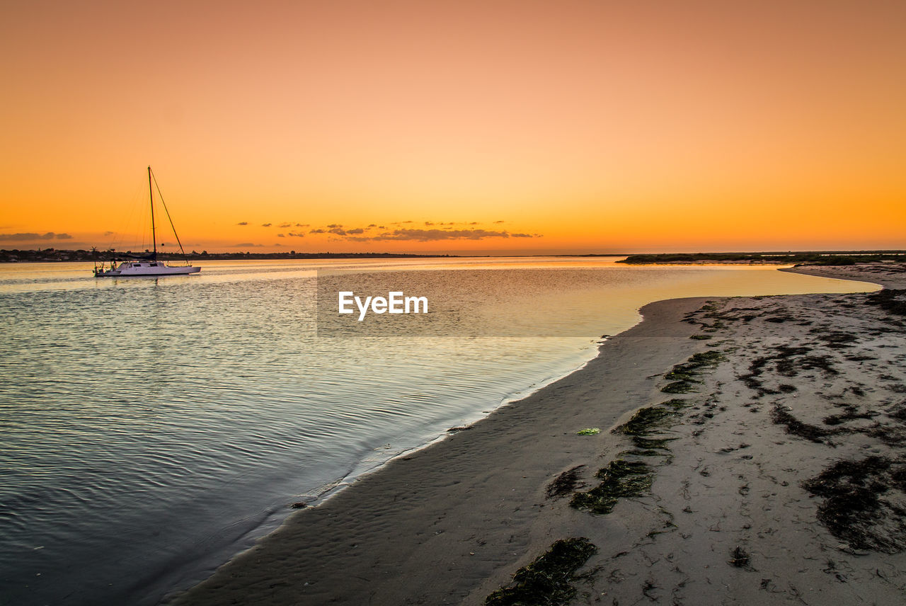 Scenic view of sea against clear sky during sunset