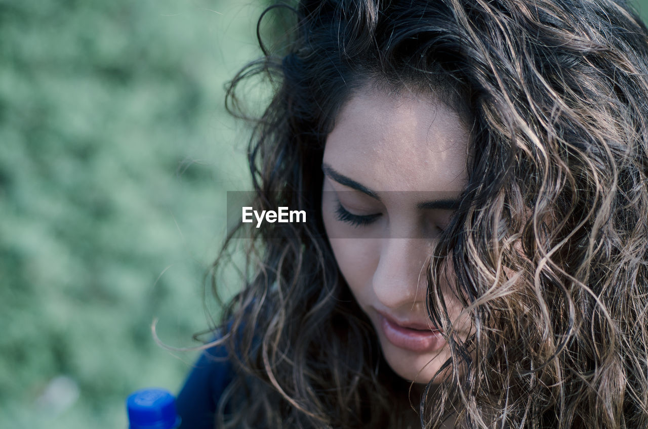 Close-up of young woman with long wavy hair