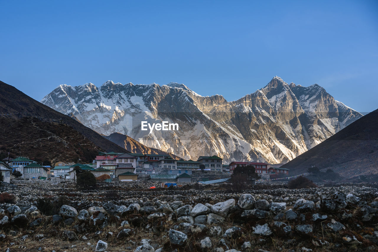 Scenic view of snowcapped mountains against clear blue sky