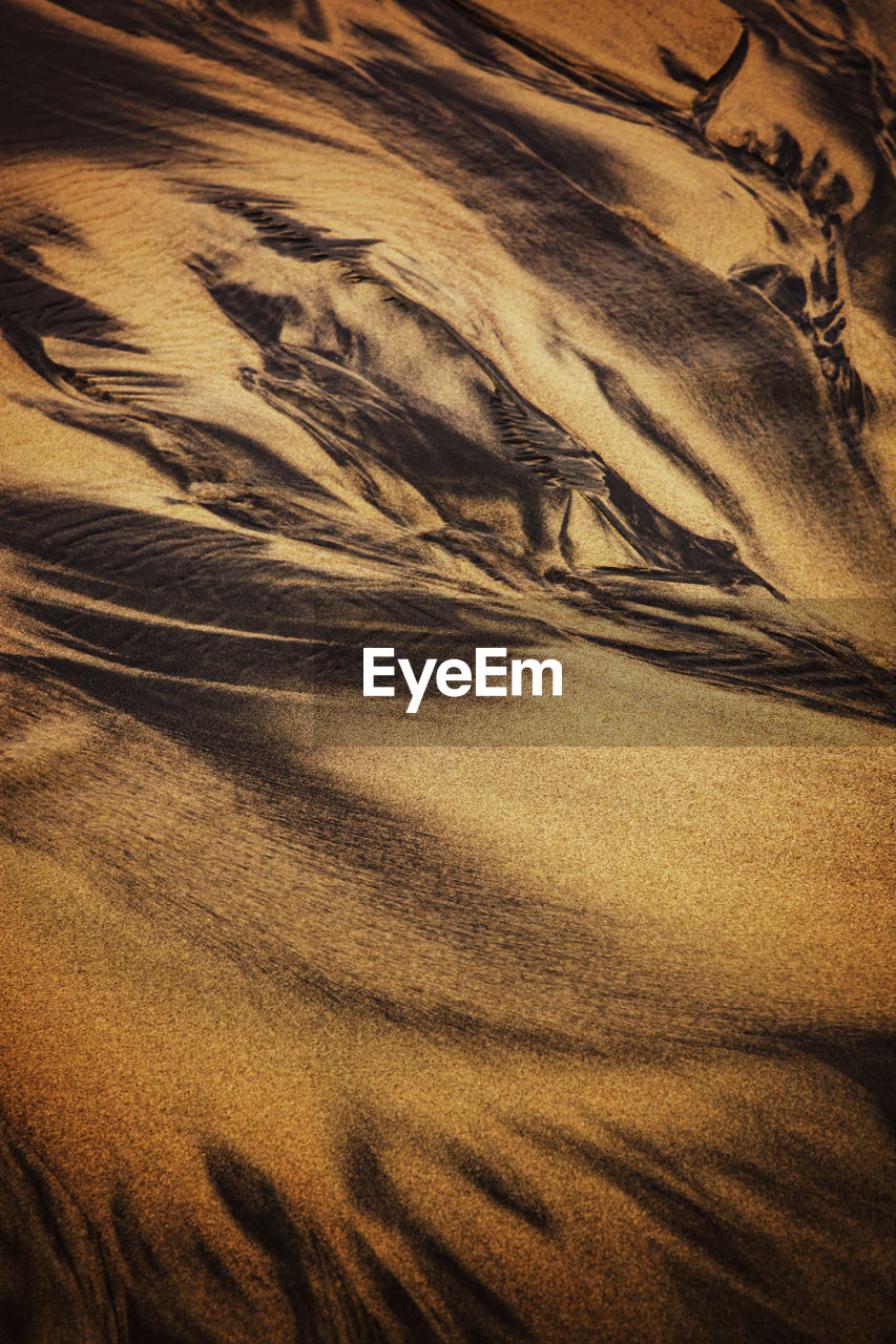 Abstract background with texture and pattern of sand with streaks and veins.