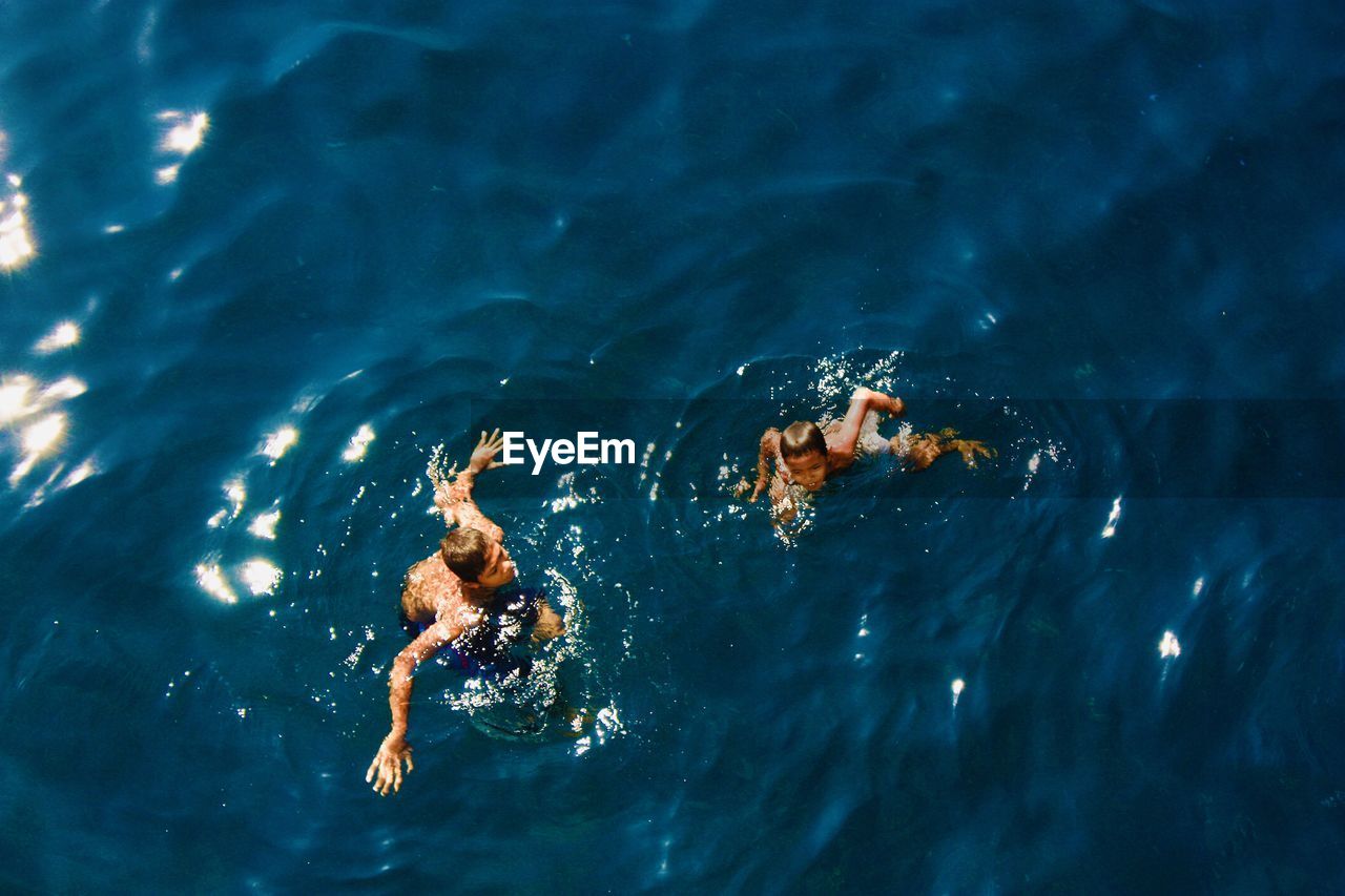 High angle view of people swimming in sea