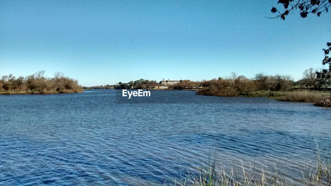 SCENIC VIEW OF LAKE AGAINST BLUE SKY