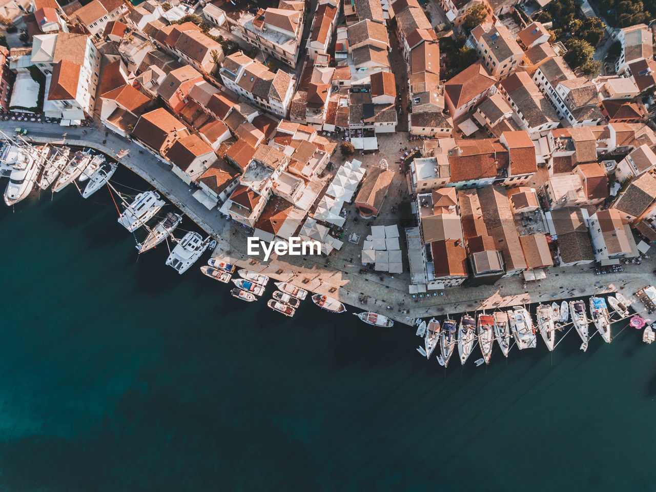 Aerial view of buildings and boats moored over sea