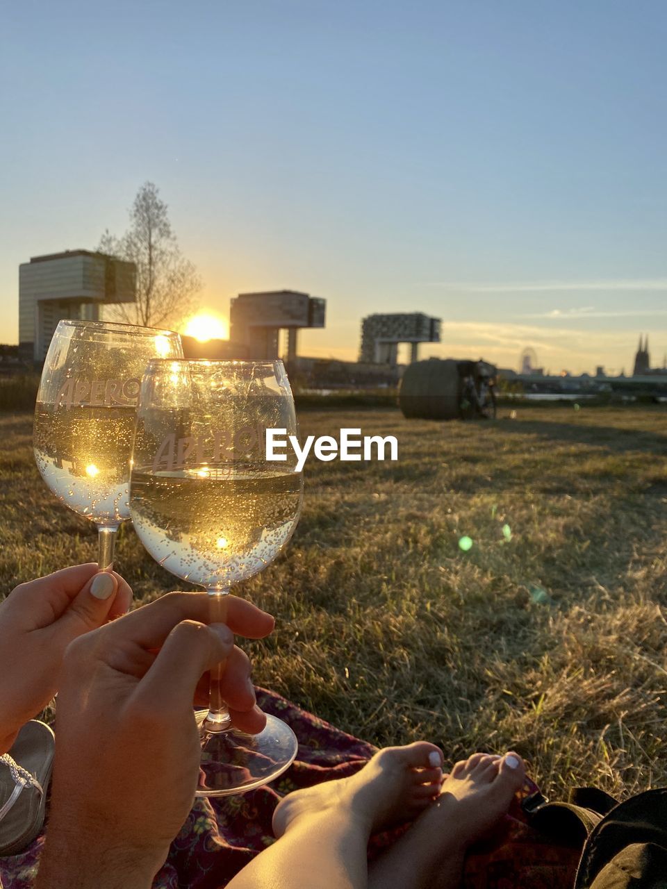 PEOPLE HOLDING GLASS ON FIELD