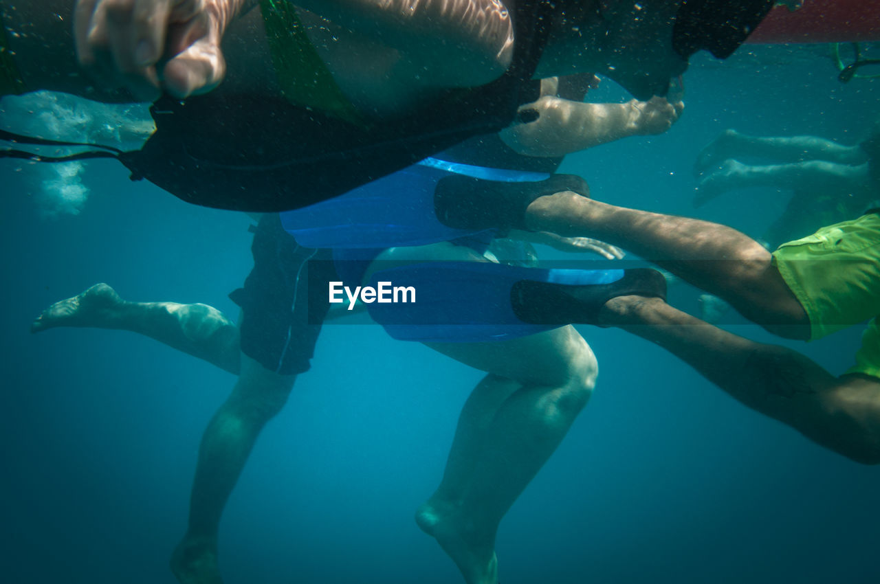 People swimming in blue sea