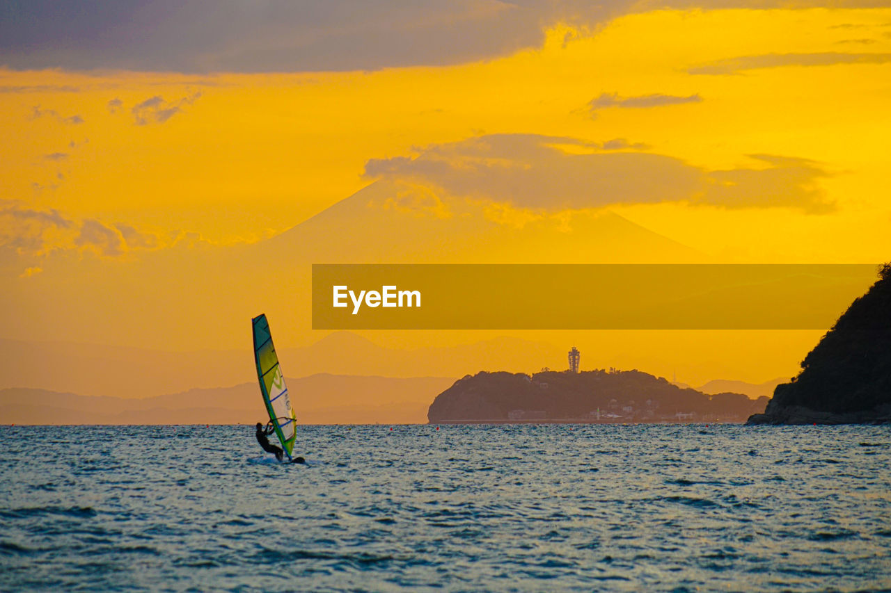 SCENIC VIEW OF SEA AGAINST ORANGE SKY DURING SUNSET