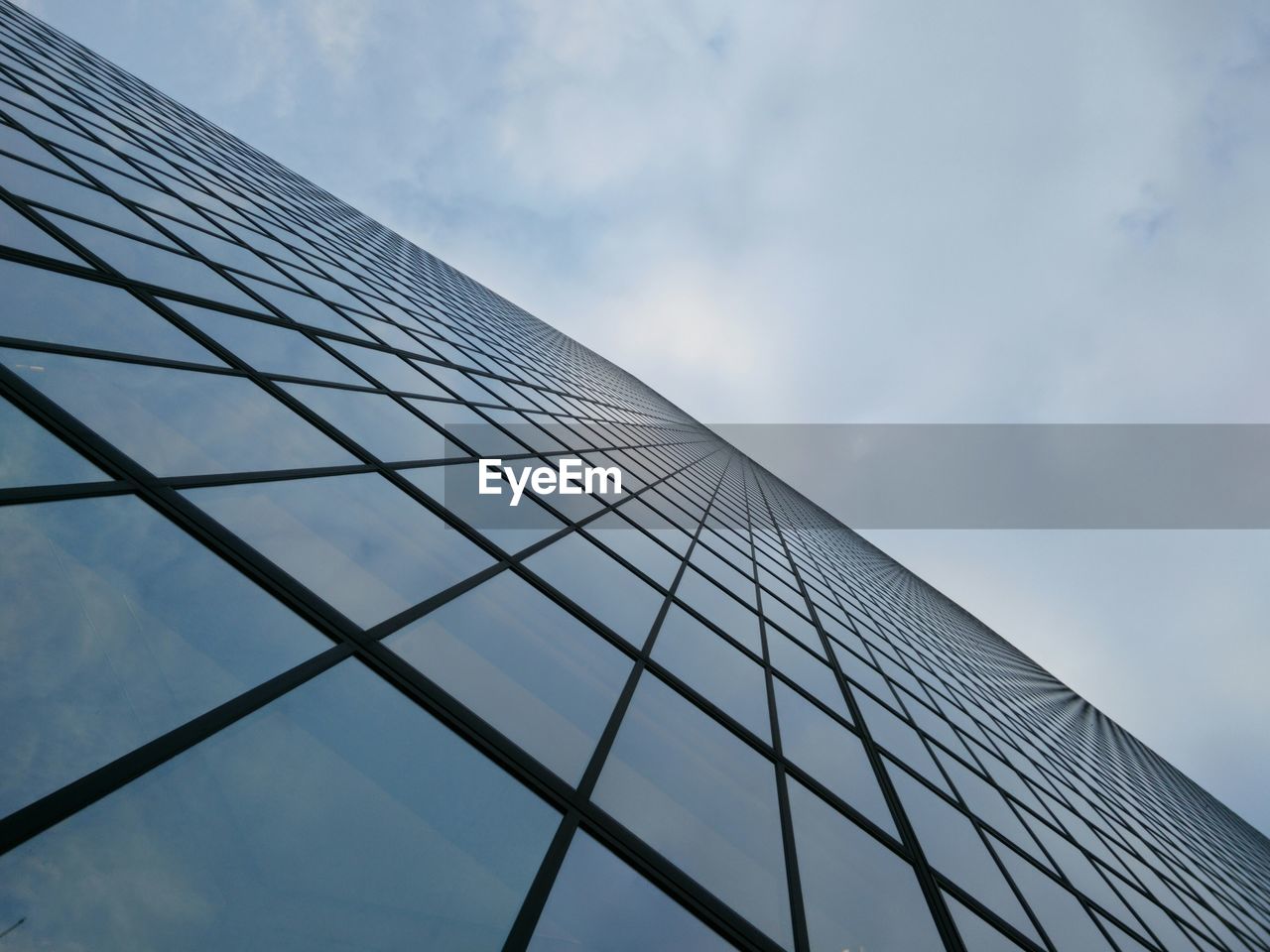 Close-up low angle view of tall building against sky