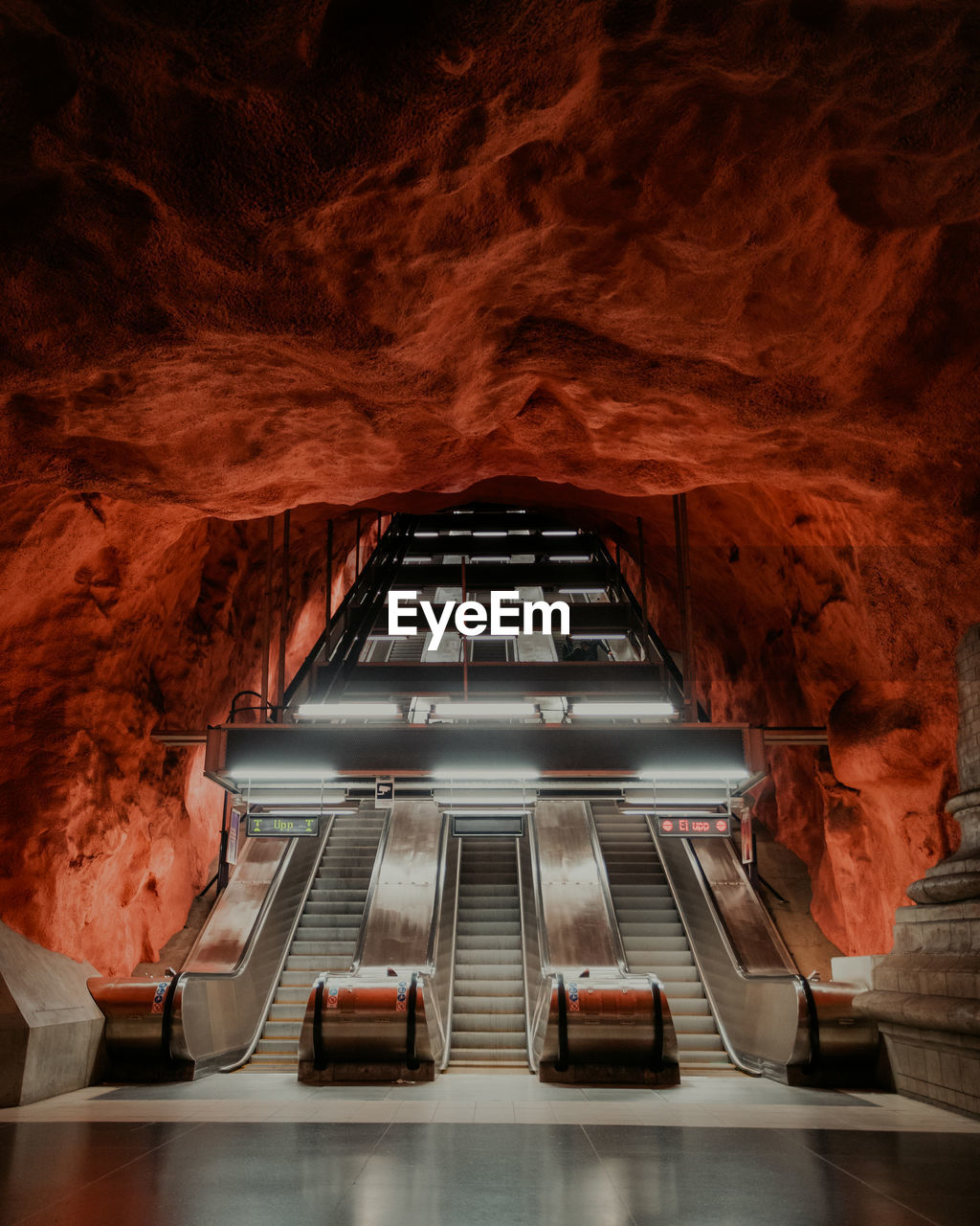 Escalator in underground cave of metro station.