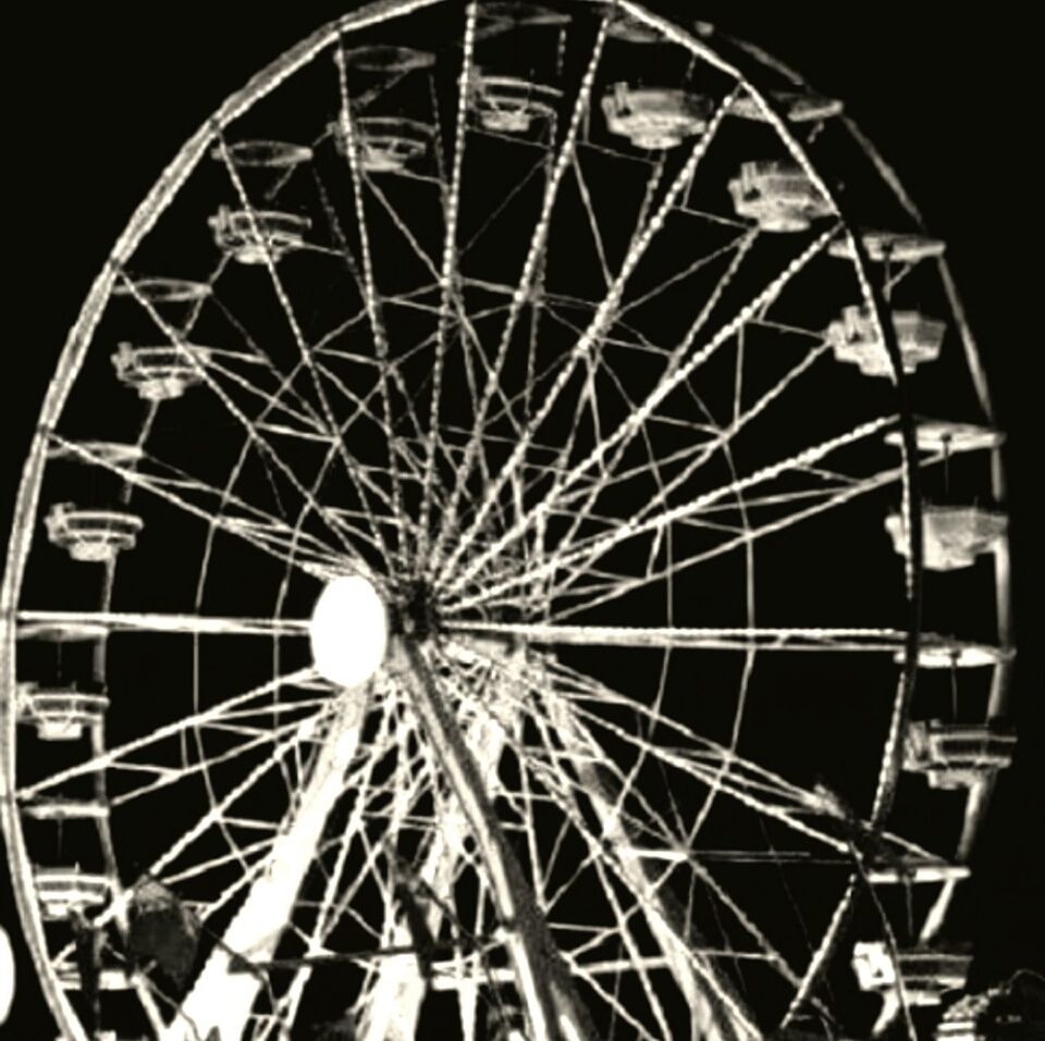 LOW ANGLE VIEW OF FERRIS WHEEL AT NIGHT