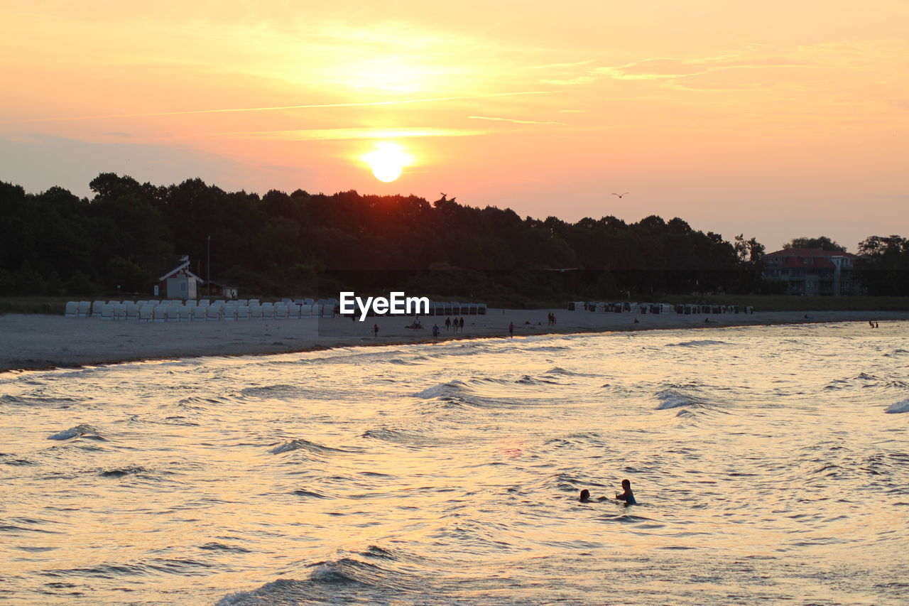 SCENIC VIEW OF BEACH AT SUNSET