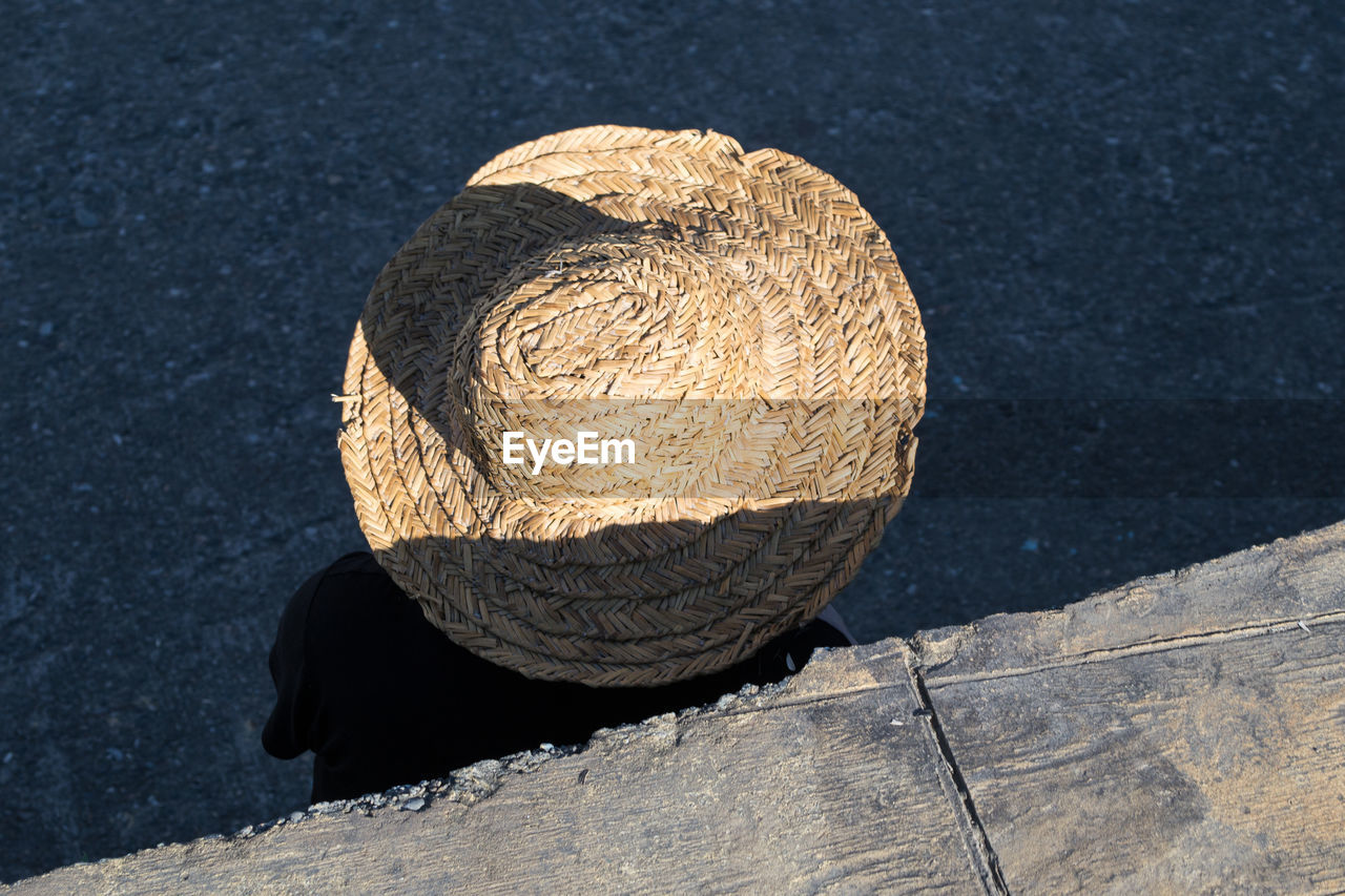 High angle view of person wearing wicket hat on street