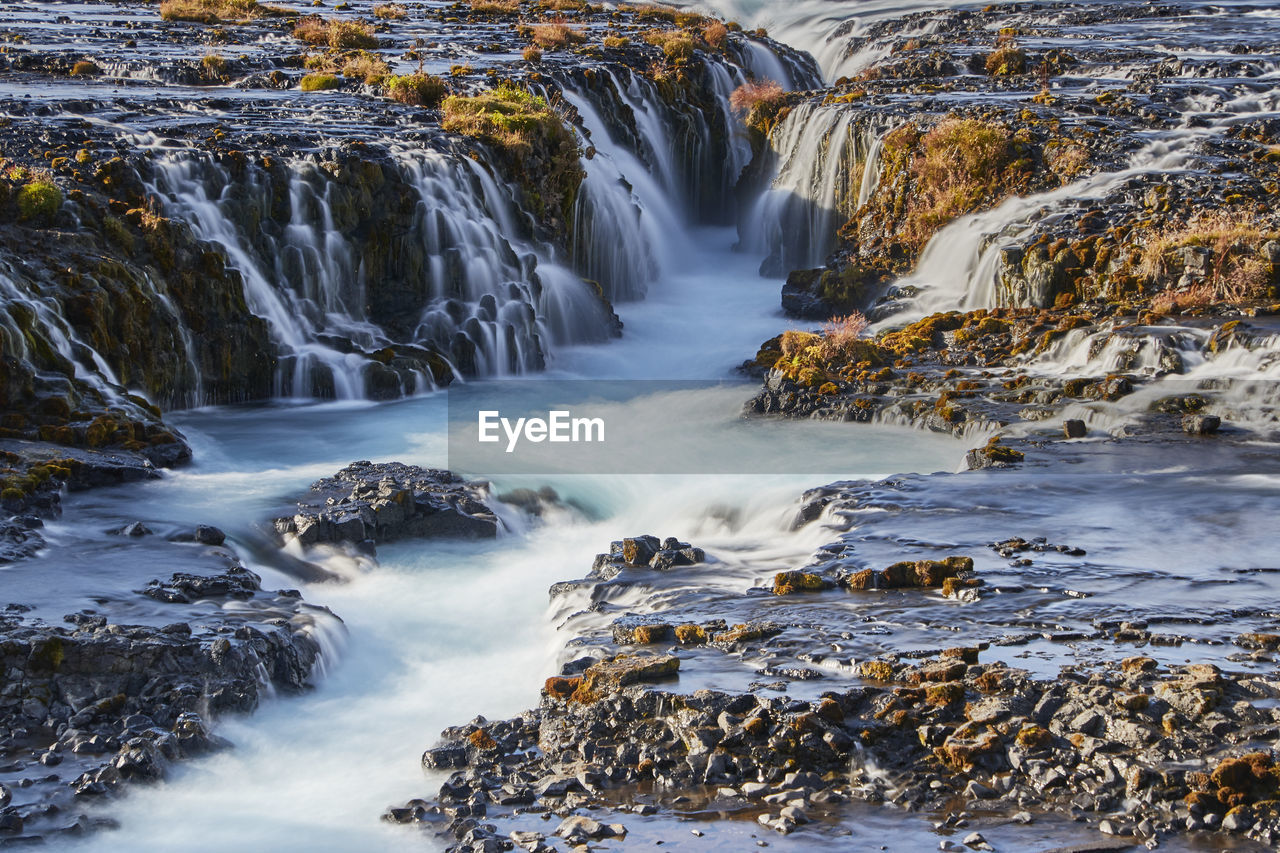 VIEW OF WATERFALL ALONG ROCKS