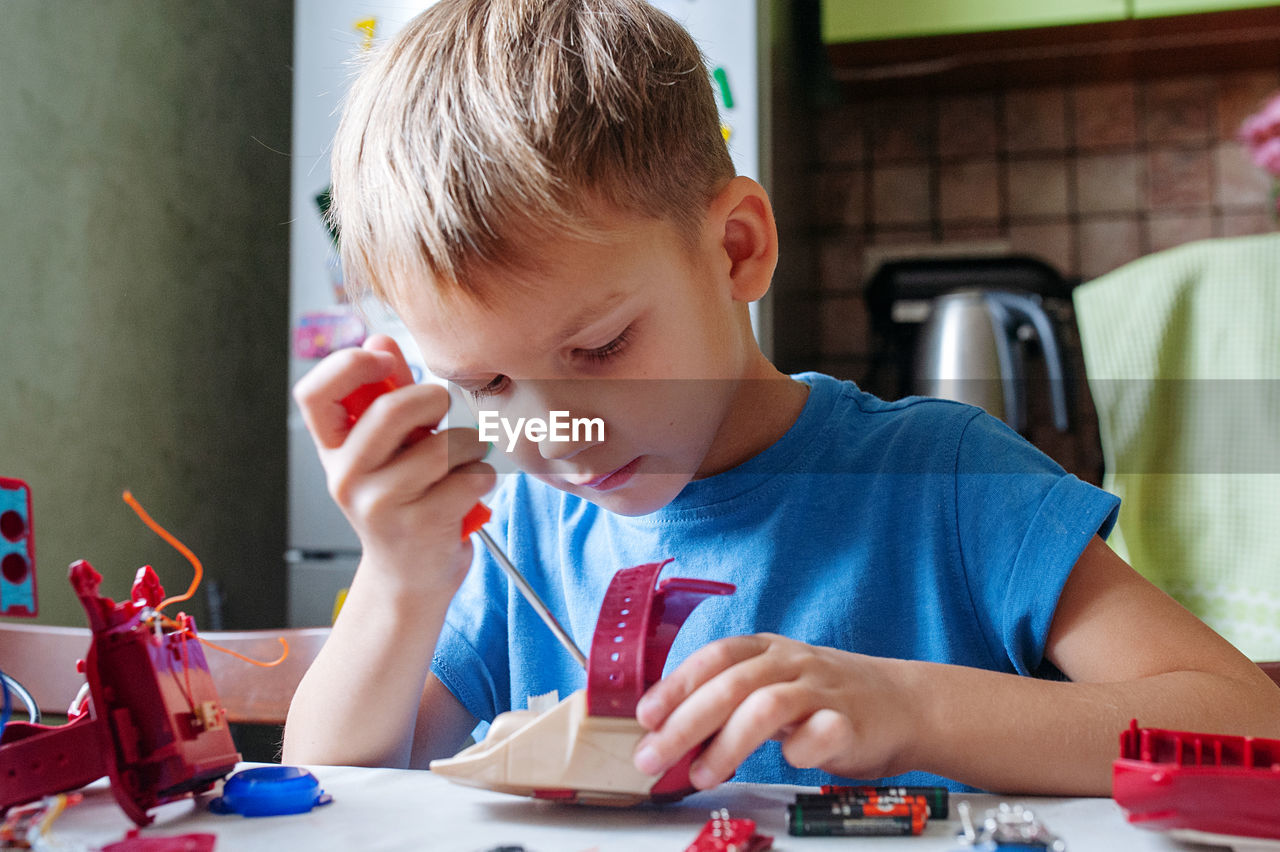 Boy playing with toy at home