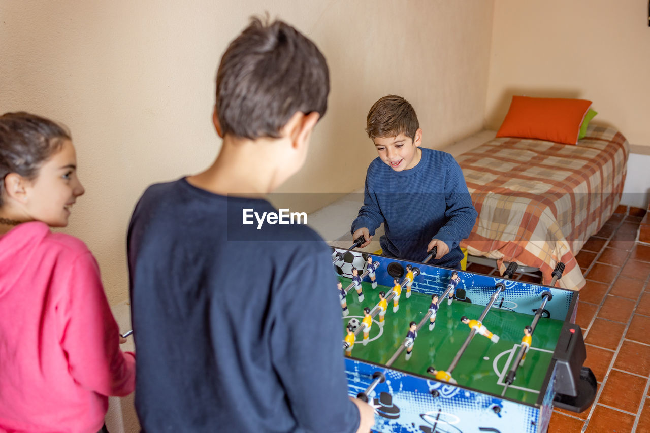 Kids playing table soccer at home