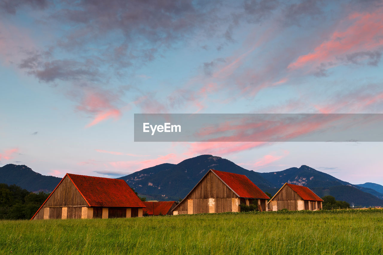 Rural landscape with traditional barns and velka fatra national park.