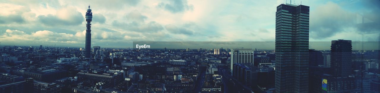 Aerial view of city against cloudy sky