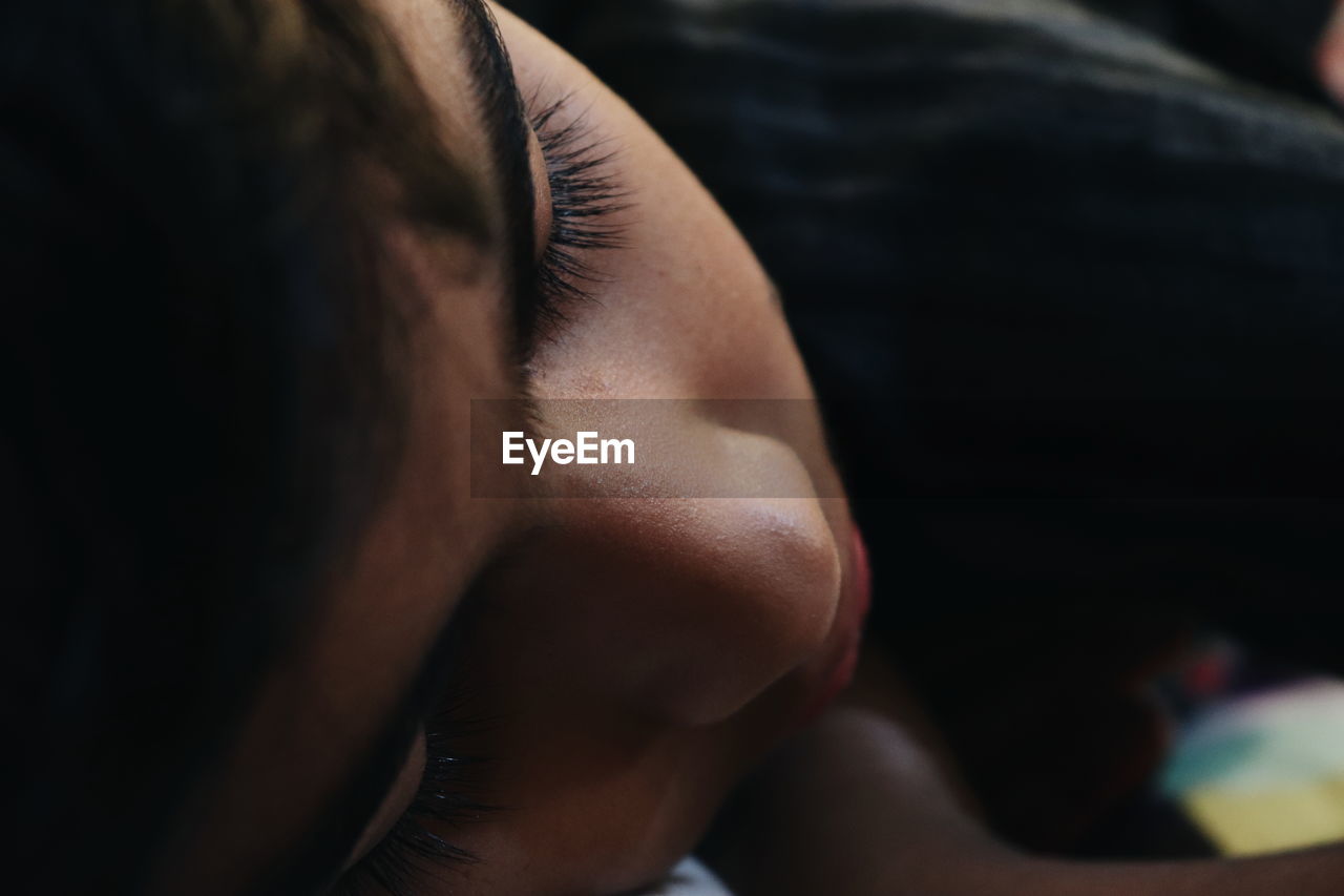 Close-up of teenage boy sleeping at home