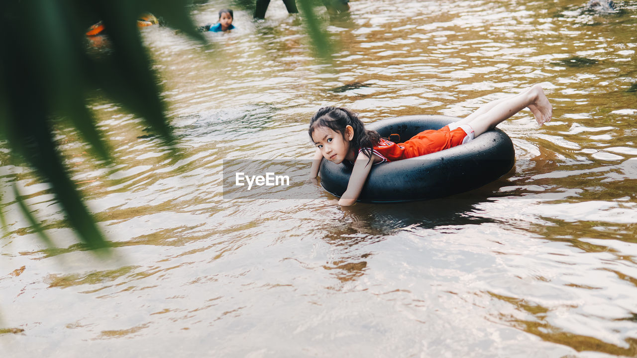 Portrait of girl on inflatable ring in lake