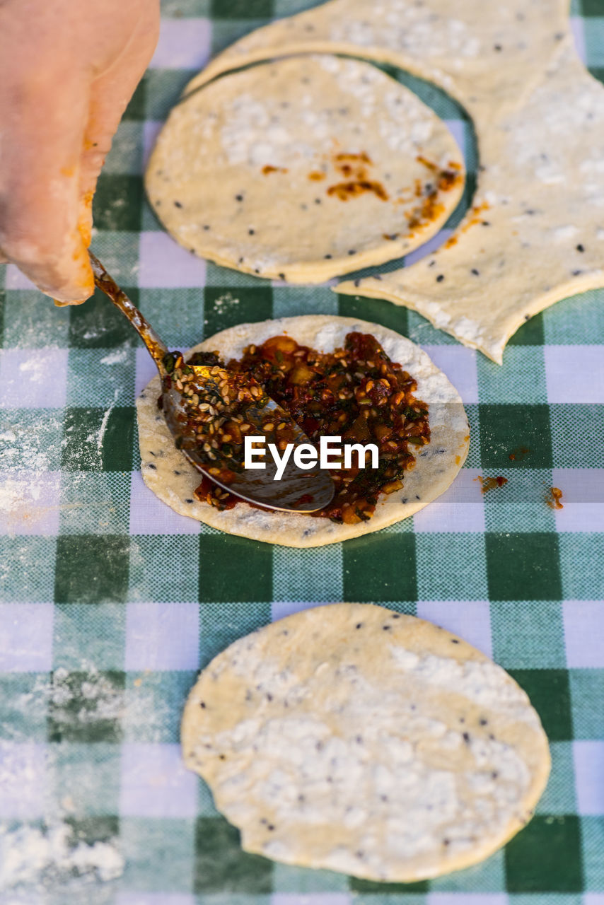 Cropped image of person preparing food on table