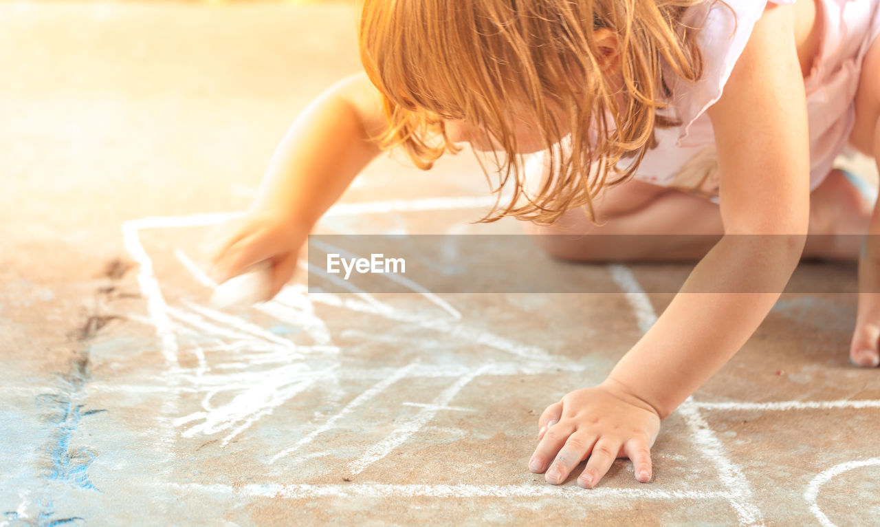 Girl drawing on floor