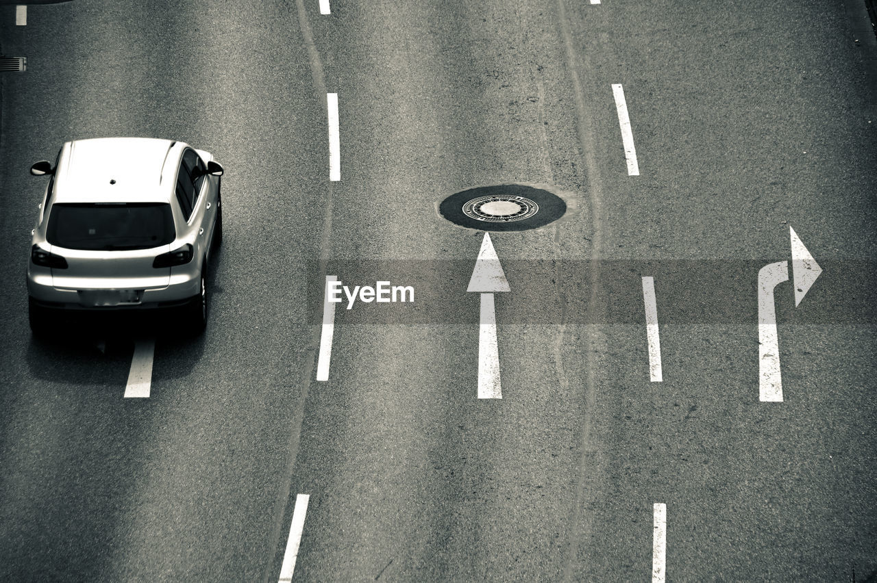 High angle view of car by road sign on street