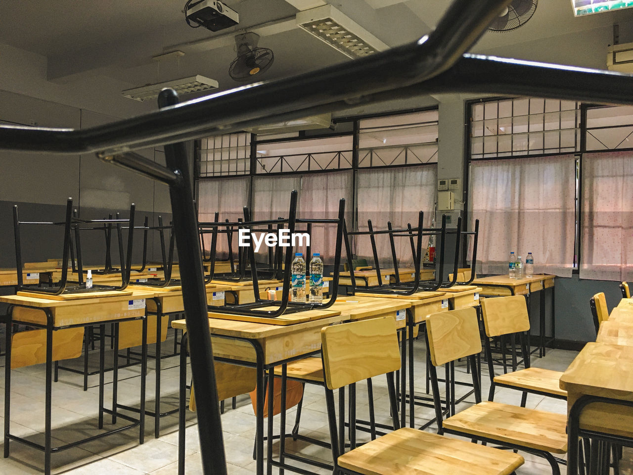 EMPTY CHAIRS AND TABLES AT RESTAURANT