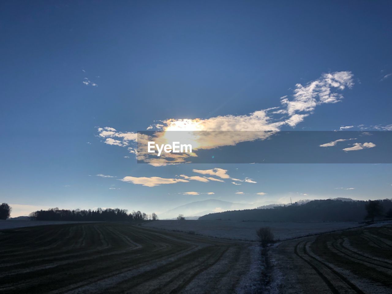 ROAD AMIDST FIELD AGAINST SKY DURING SUNRISE