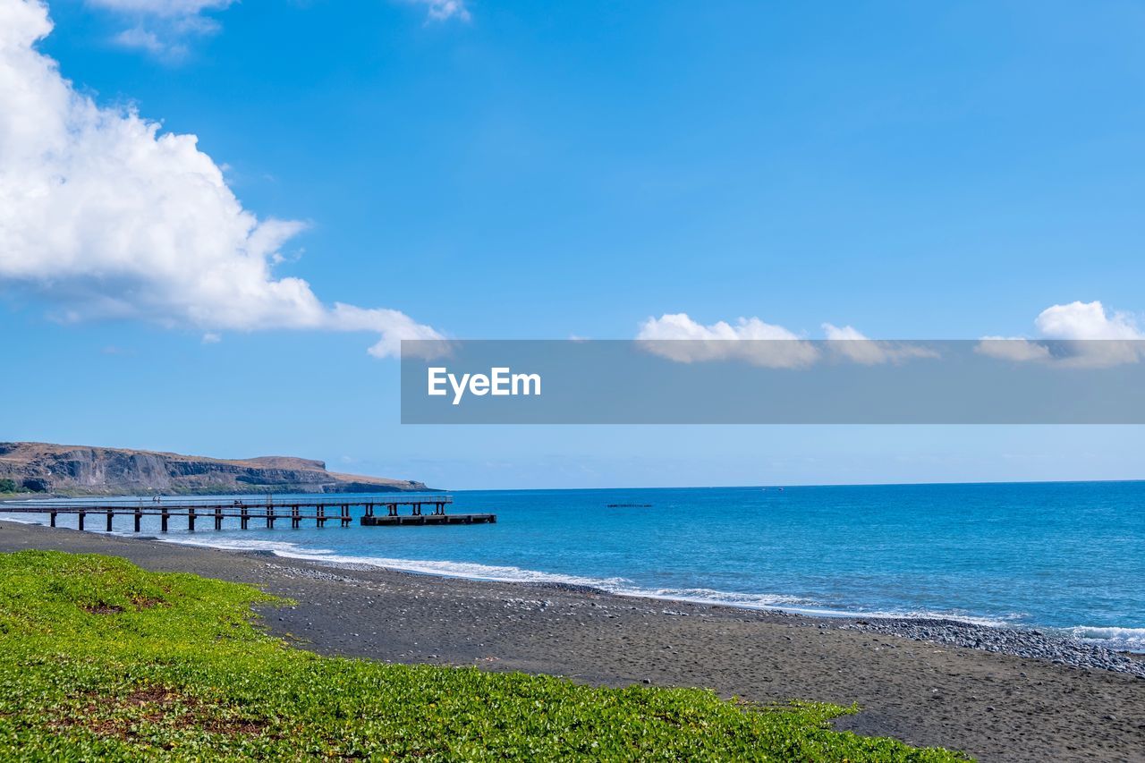 Scenic view of sea against blue sky