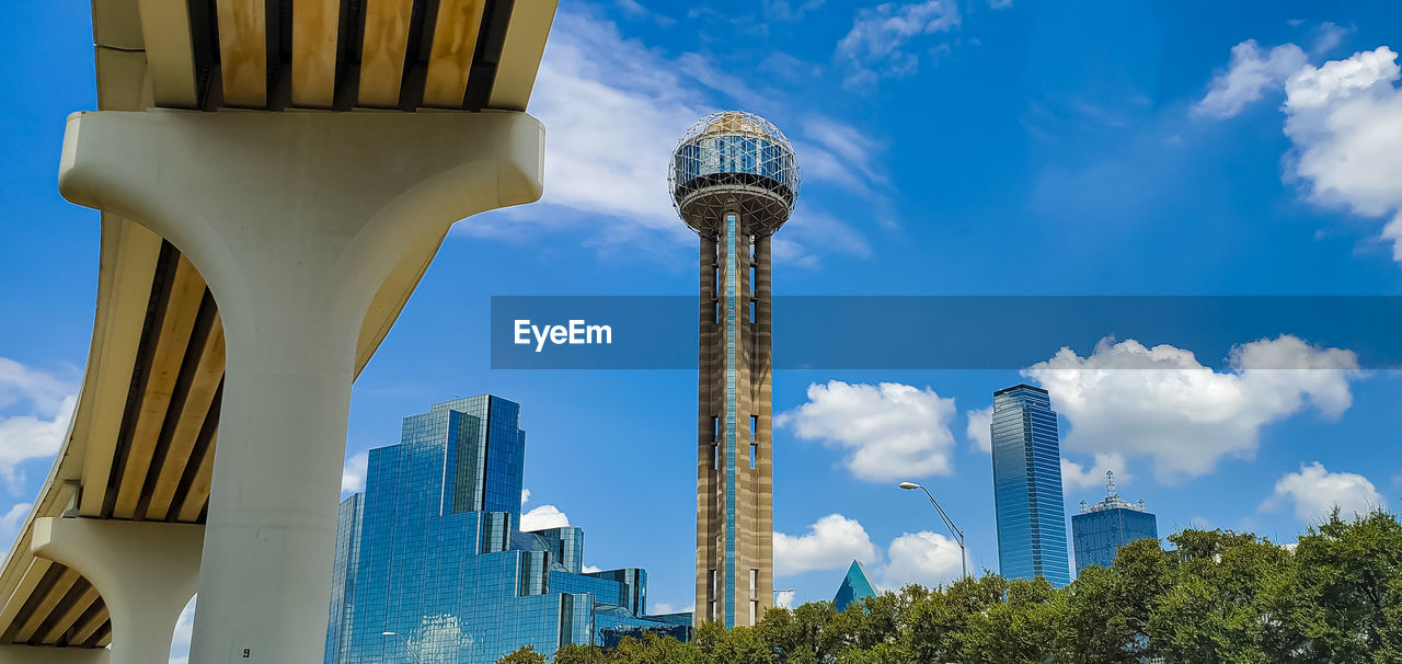 Low angle view of buildings against cloudy sky