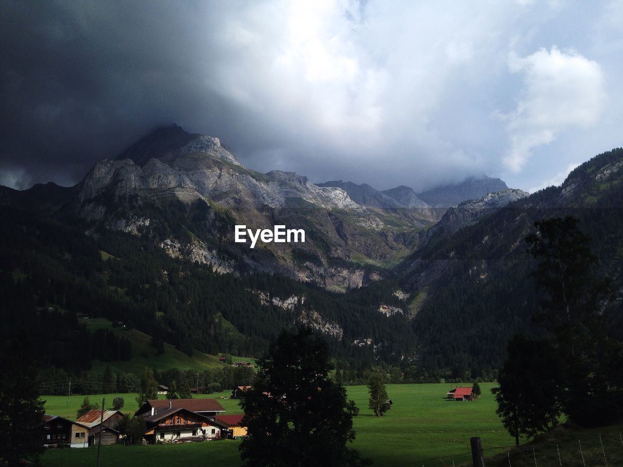 SCENIC VIEW OF MOUNTAINS AGAINST CLOUDY SKY