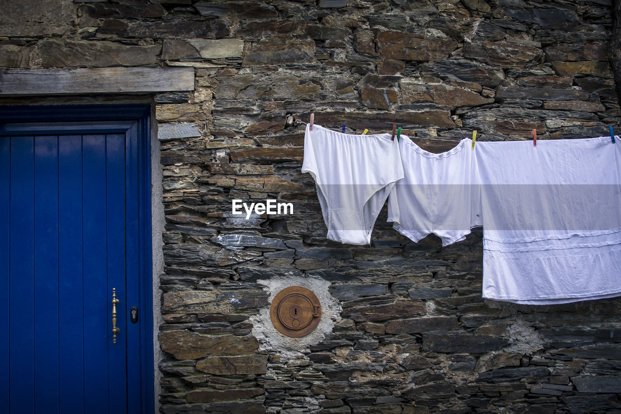 Clothes drying against  wall