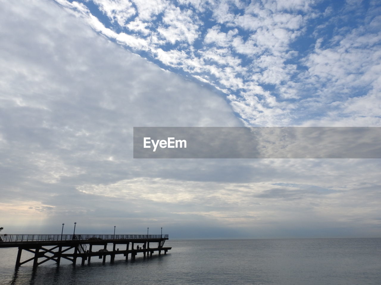 Pier over sea against sky