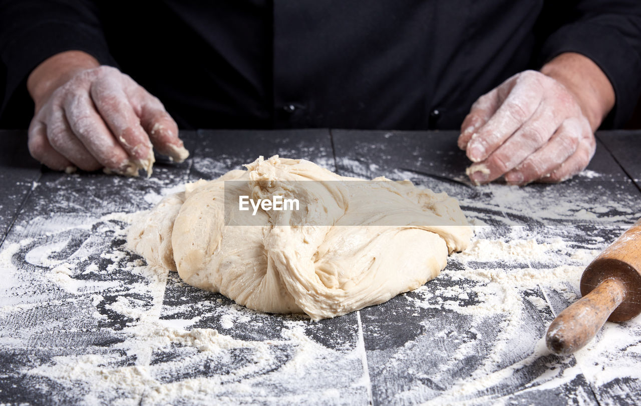 Midsection of chef preparing food at table