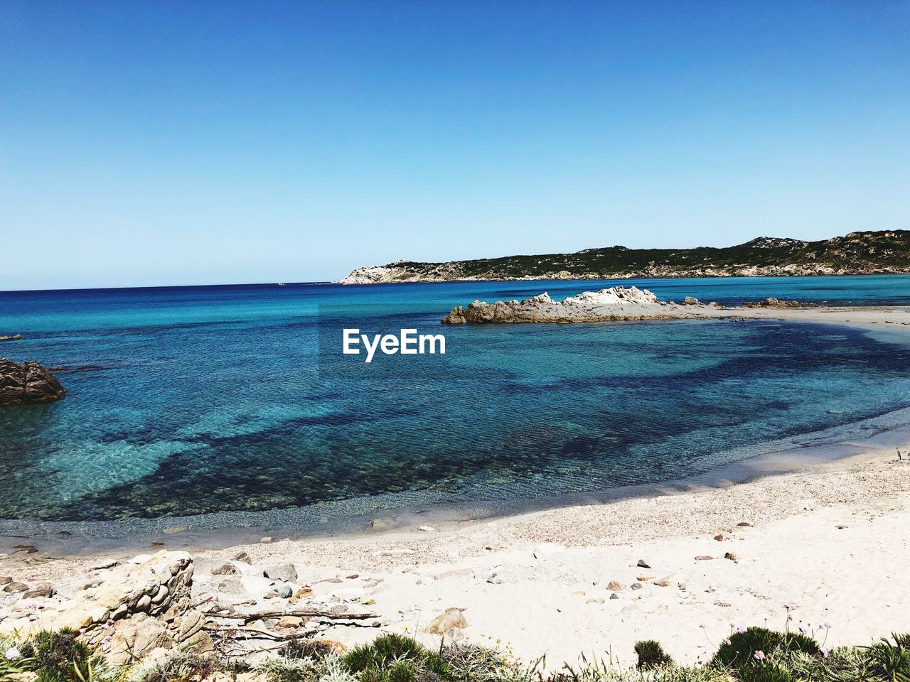 Scenic view of sea against clear blue sky