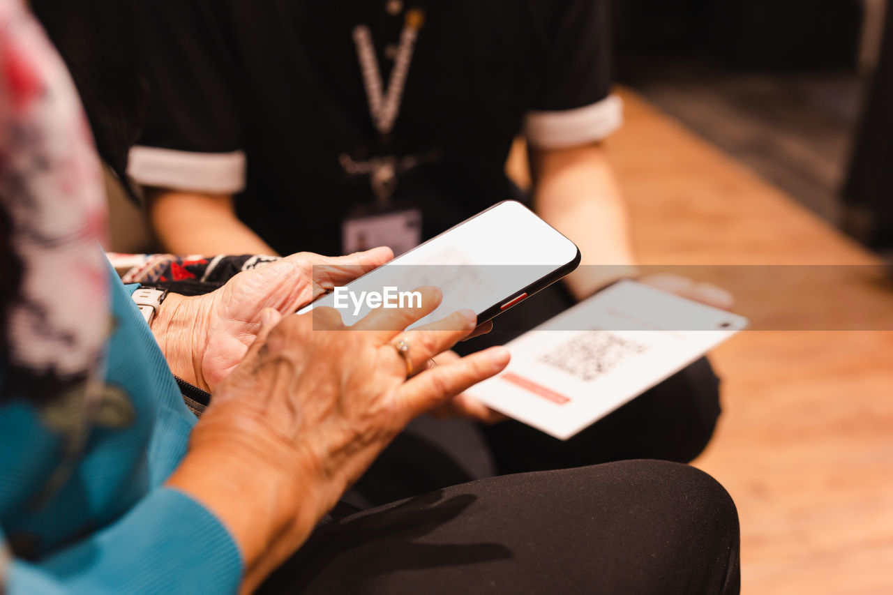 Midsection of woman using mobile phone