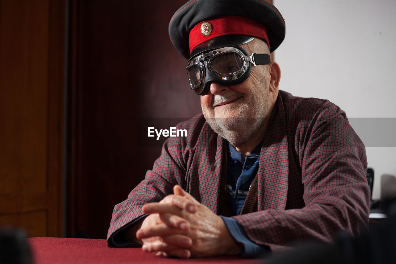 Smiling senior man wearing aviator glasses and cap