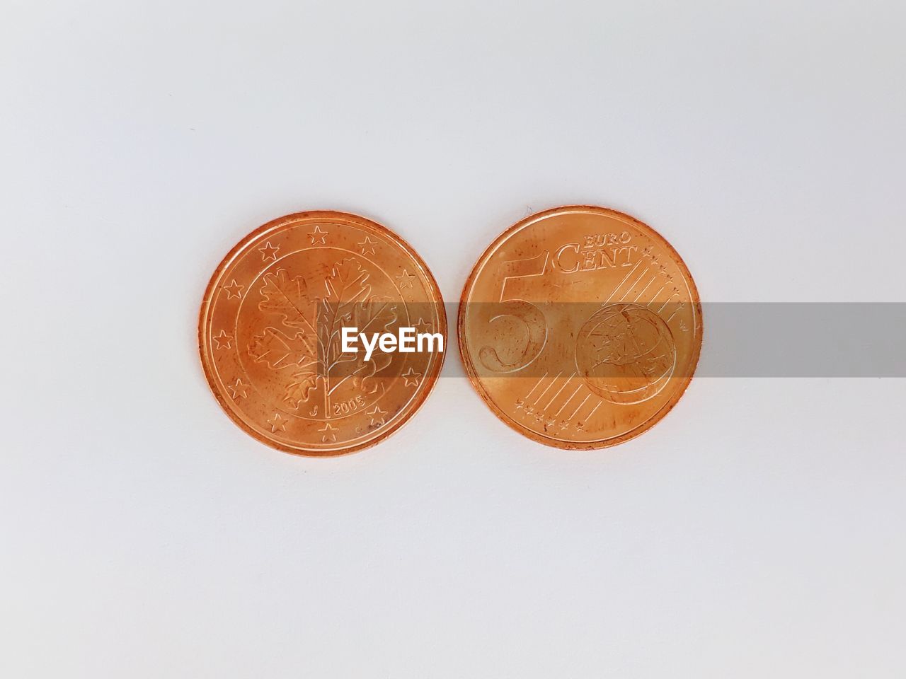 HIGH ANGLE VIEW OF COINS IN WHITE BACKGROUND