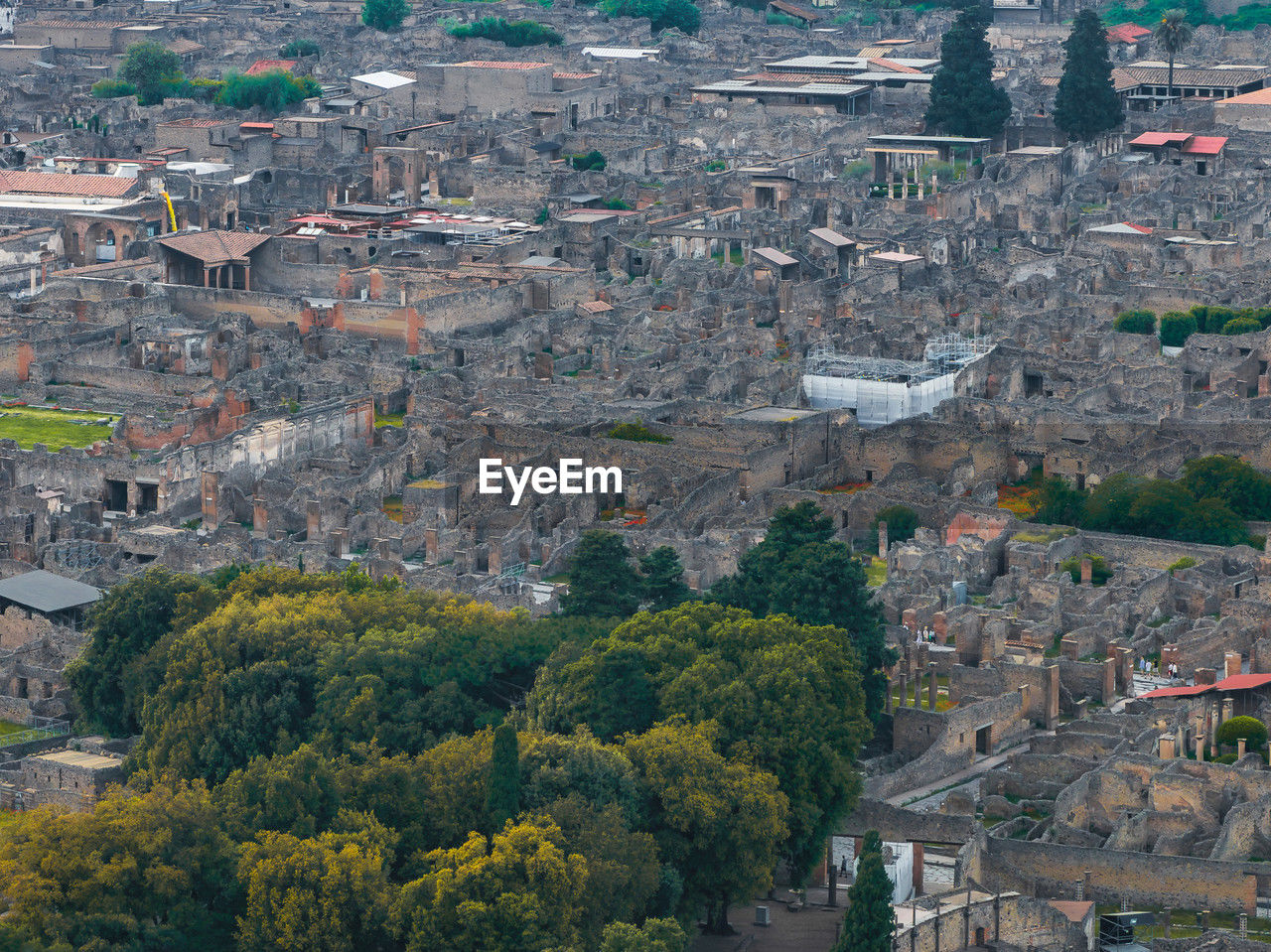 aerial photography, architecture, town, built structure, city, building exterior, high angle view, tree, cityscape, building, plant, bird's-eye view, nature, residential district, landscape, residential area, outdoors, environment, aerial view, no people, day, land, house, travel destinations, roof, travel, urban area, history, tourism, the past, religion, suburb