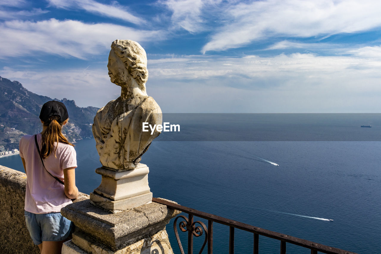 REAR VIEW OF STATUE ON SEA AGAINST SKY